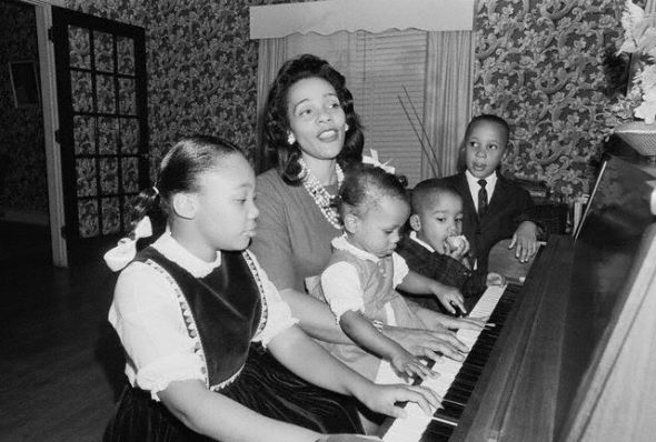 Coretta and the four King children, playing piano