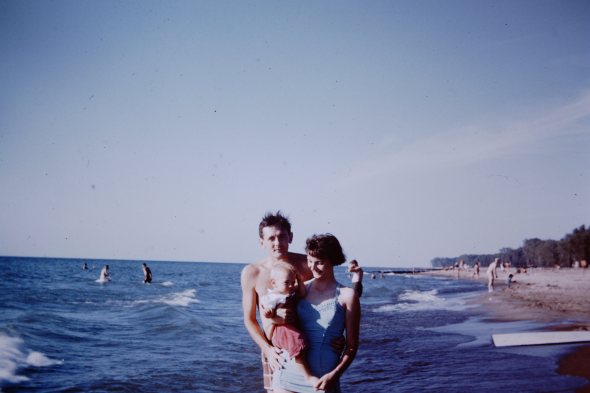 My parents in younger days [1957], with a little me.